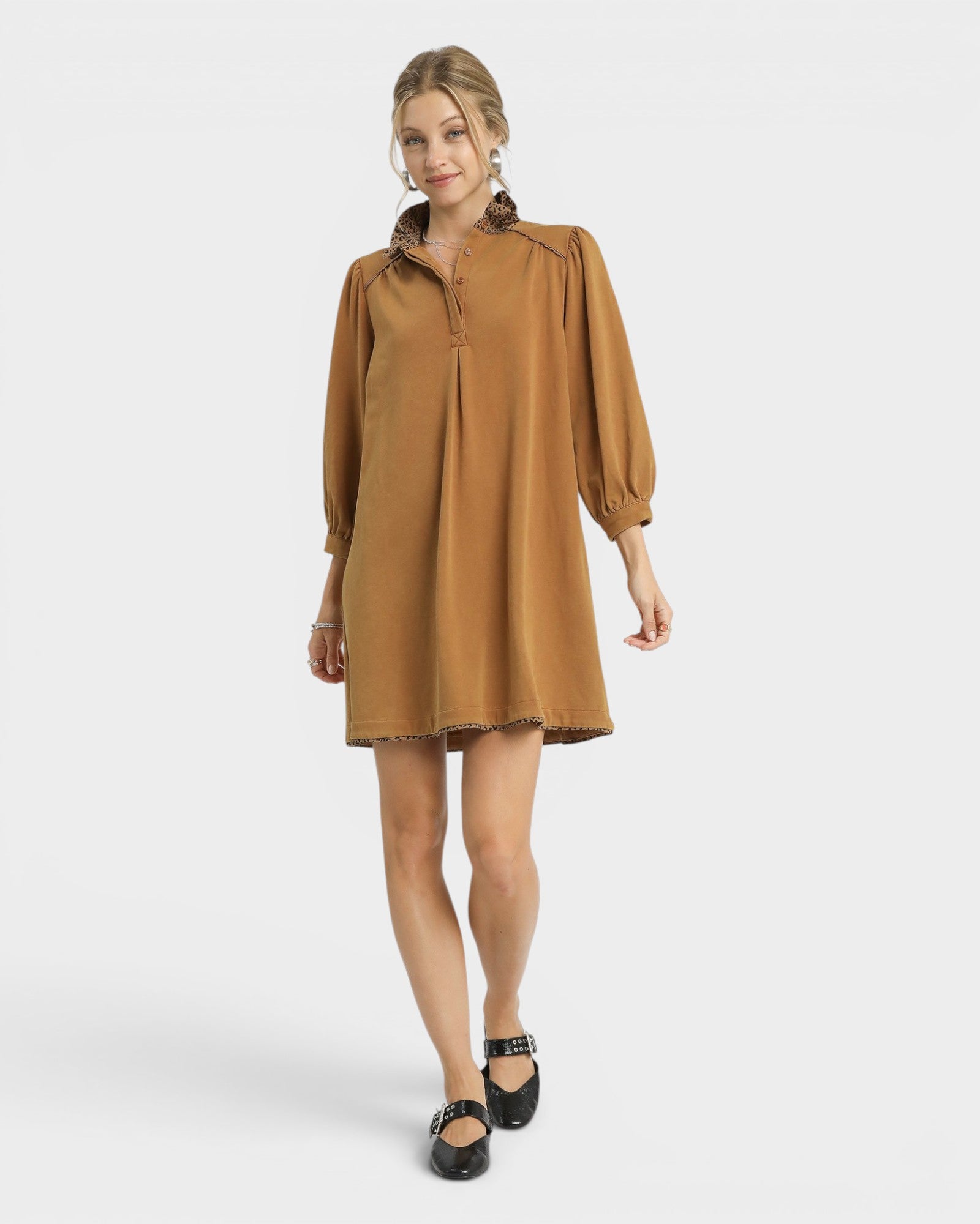 Woman wearing a brown dress on a white background