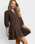 Woman wearing a brown dress with a white background