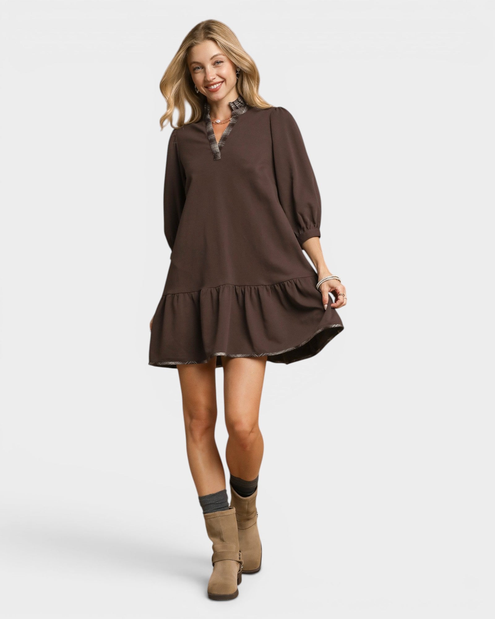 Woman wearing a brown dress with a white background