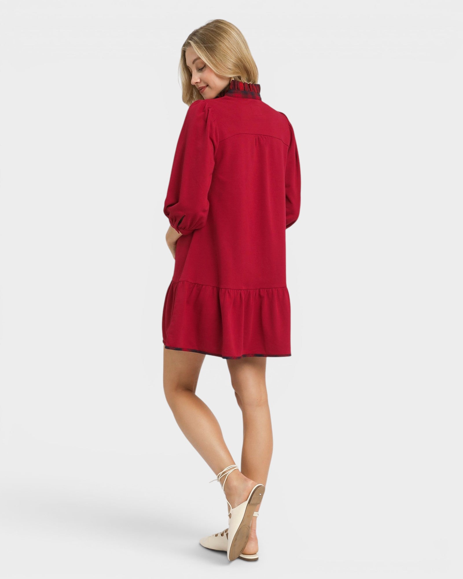 Woman wearing a red dress on a white background