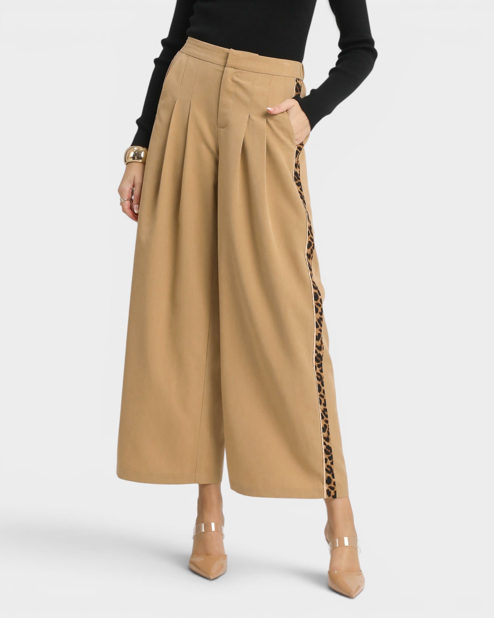 Beige wide-leg pants with leopard print side panels worn by a person on a white background
