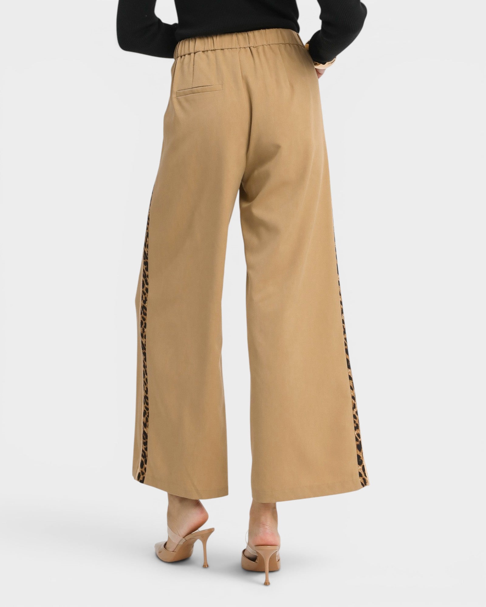 Beige wide-leg pants with leopard print side panels on a white background