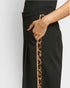Black pants with a leopard print trim on a plain background