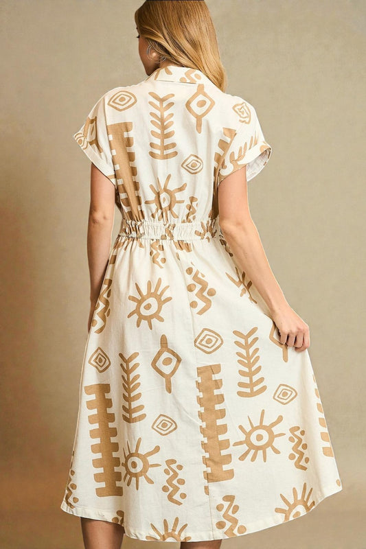 Woman wearing a white dress with brown patterns against a beige background