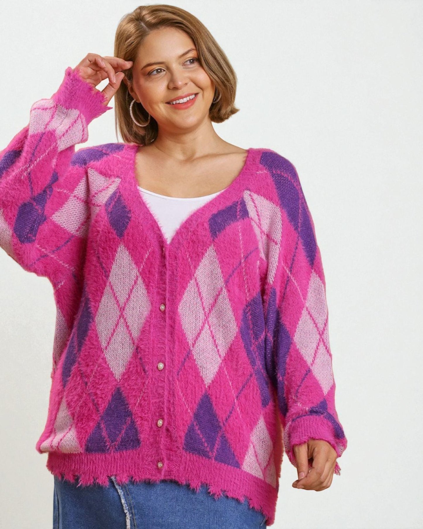 Woman wearing a pink and purple argyle patterned cardigan on a white background