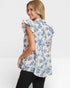 Woman wearing a blue floral blouse on a white background