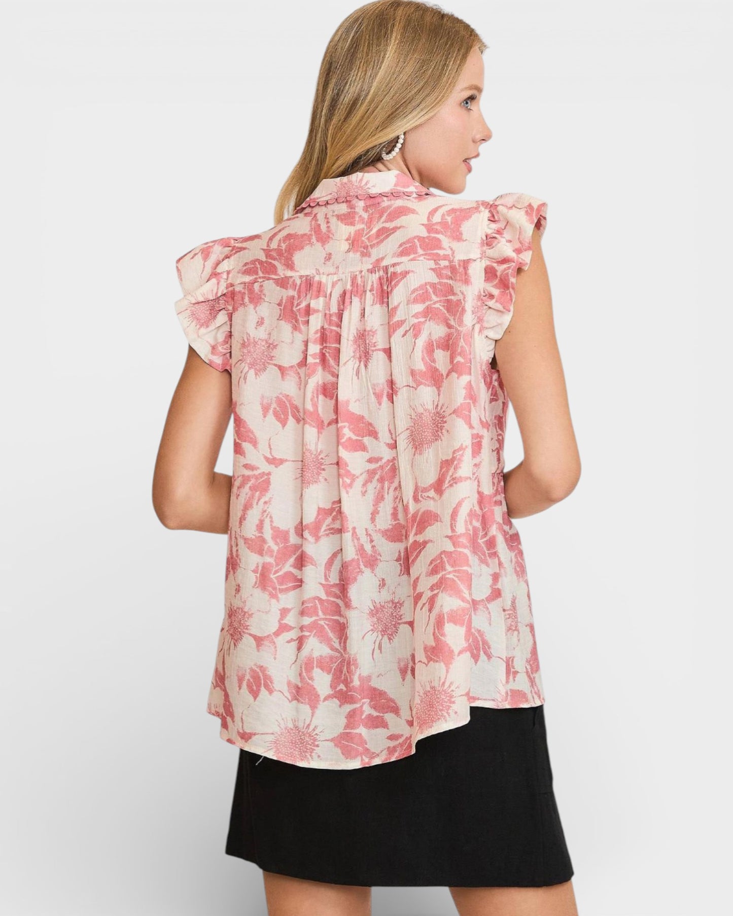 Woman wearing a pink floral blouse on a white background