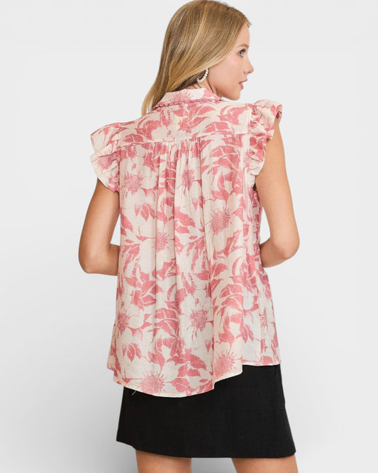 Woman wearing a pink floral blouse on a white background