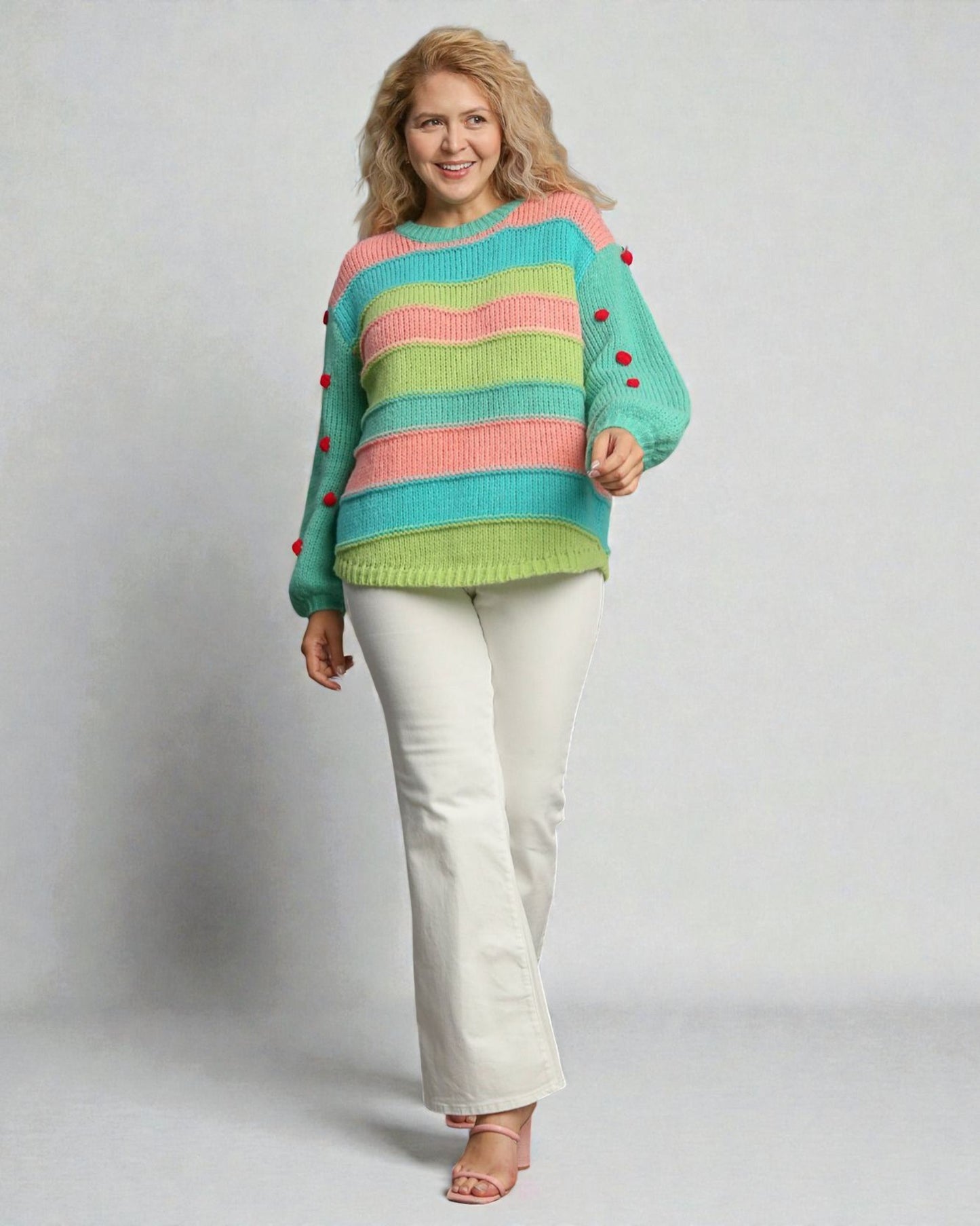 Woman wearing a colorful striped sweater with buttons on a plain background