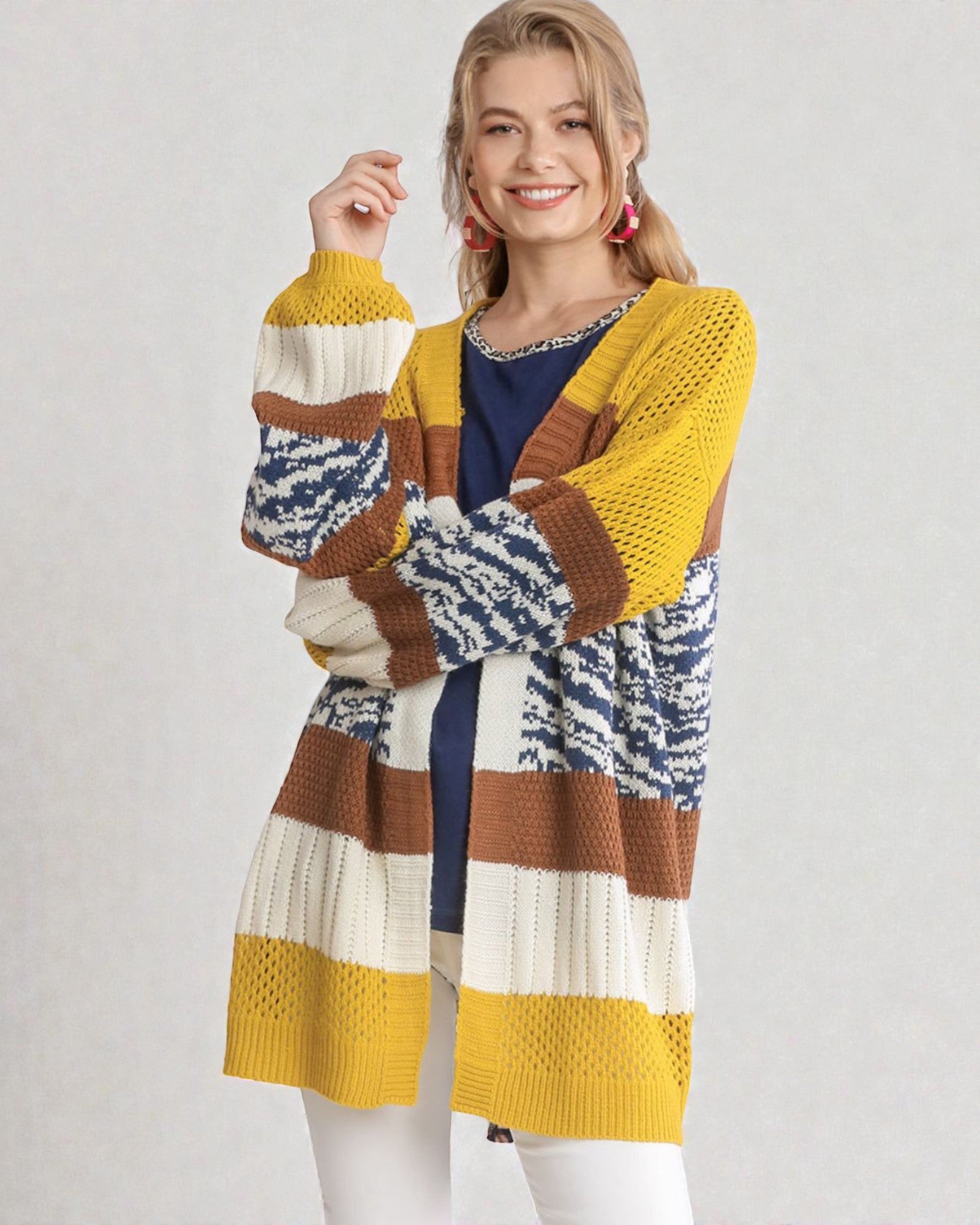 Woman wearing a colorful striped sweater on a plain background