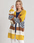 Woman wearing a colorful striped sweater on a plain background