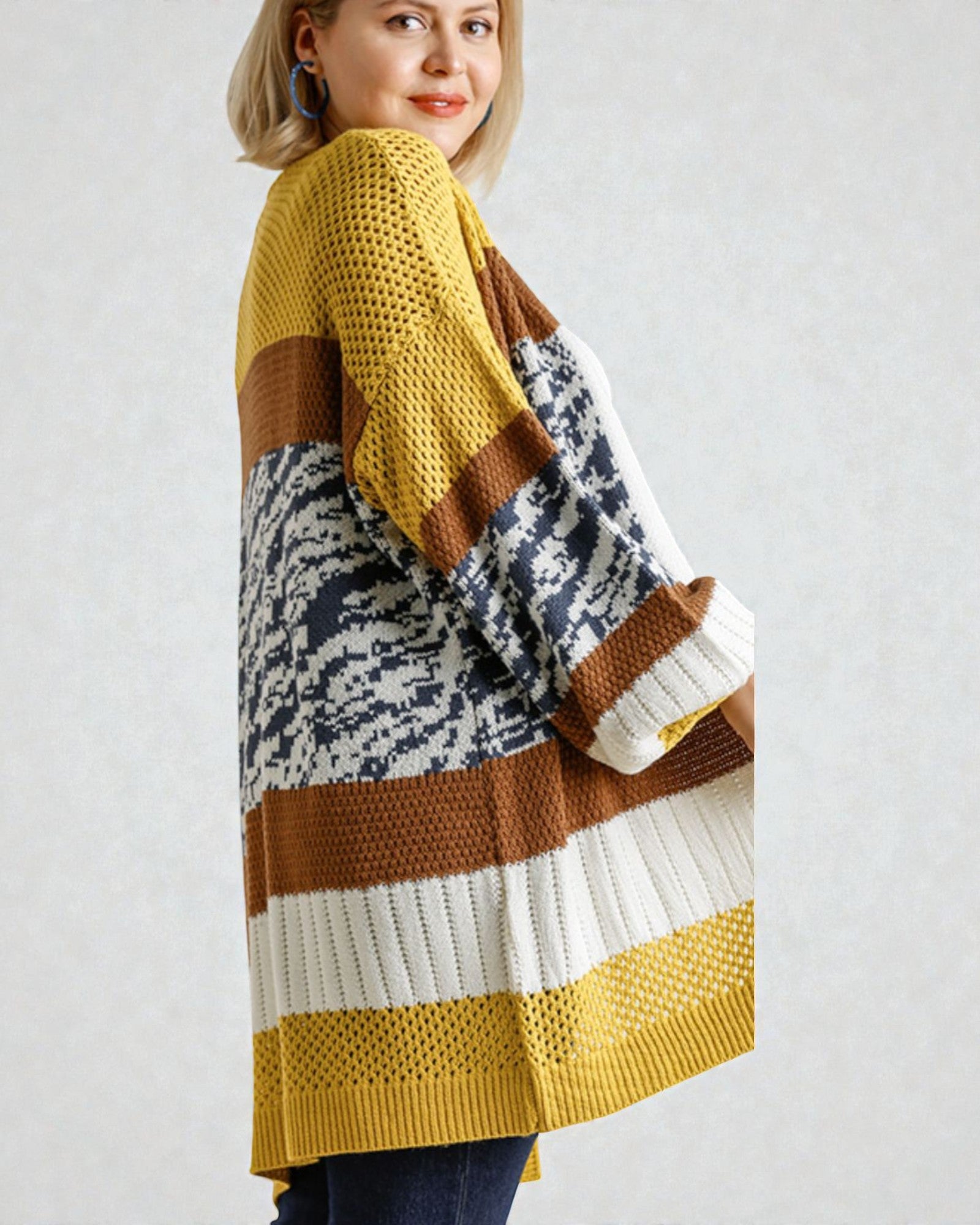 Woman wearing a colorful striped sweater against a plain background