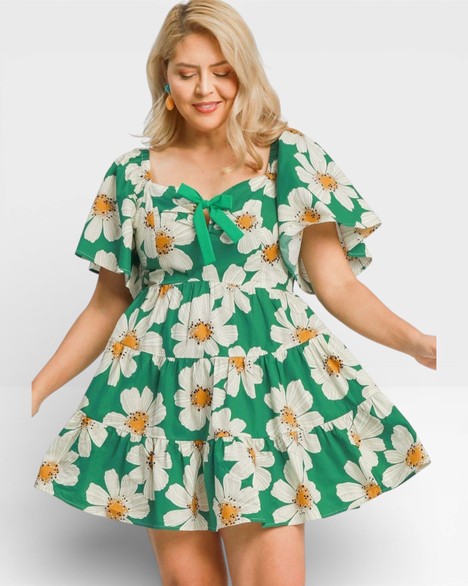 Woman wearing a green floral dress on a white background