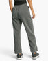 A person shown from the back wearing heather gray lounge pants, a black top, and dark sneakers against a clean light gray studio background.