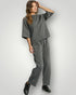 Woman wearing a gray outfit on a white background