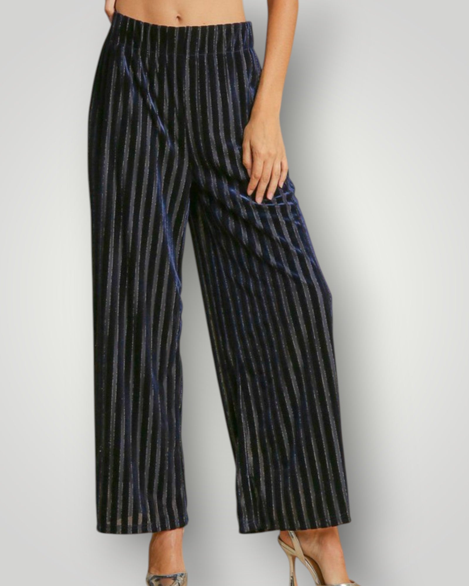 Navy striped pants worn by a person on a light gray background