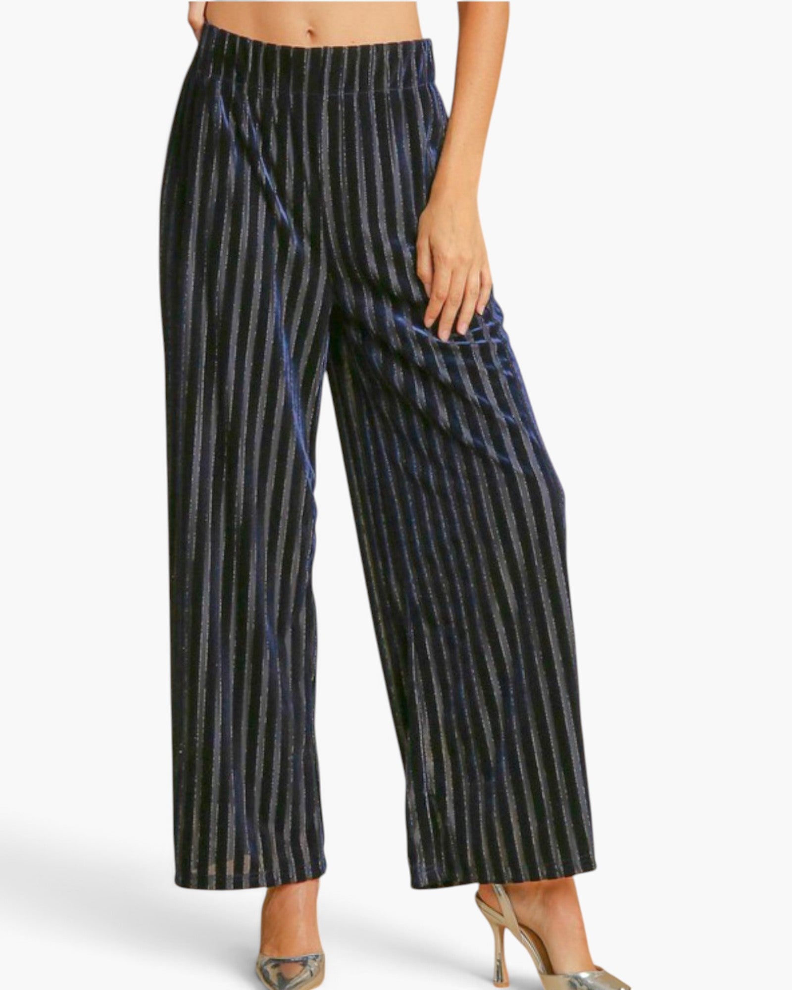 A model wearing high-waisted, wide-leg cropped pants with a black and metallic silver vertical stripe pattern, paired with metallic high heels against a plain white background.