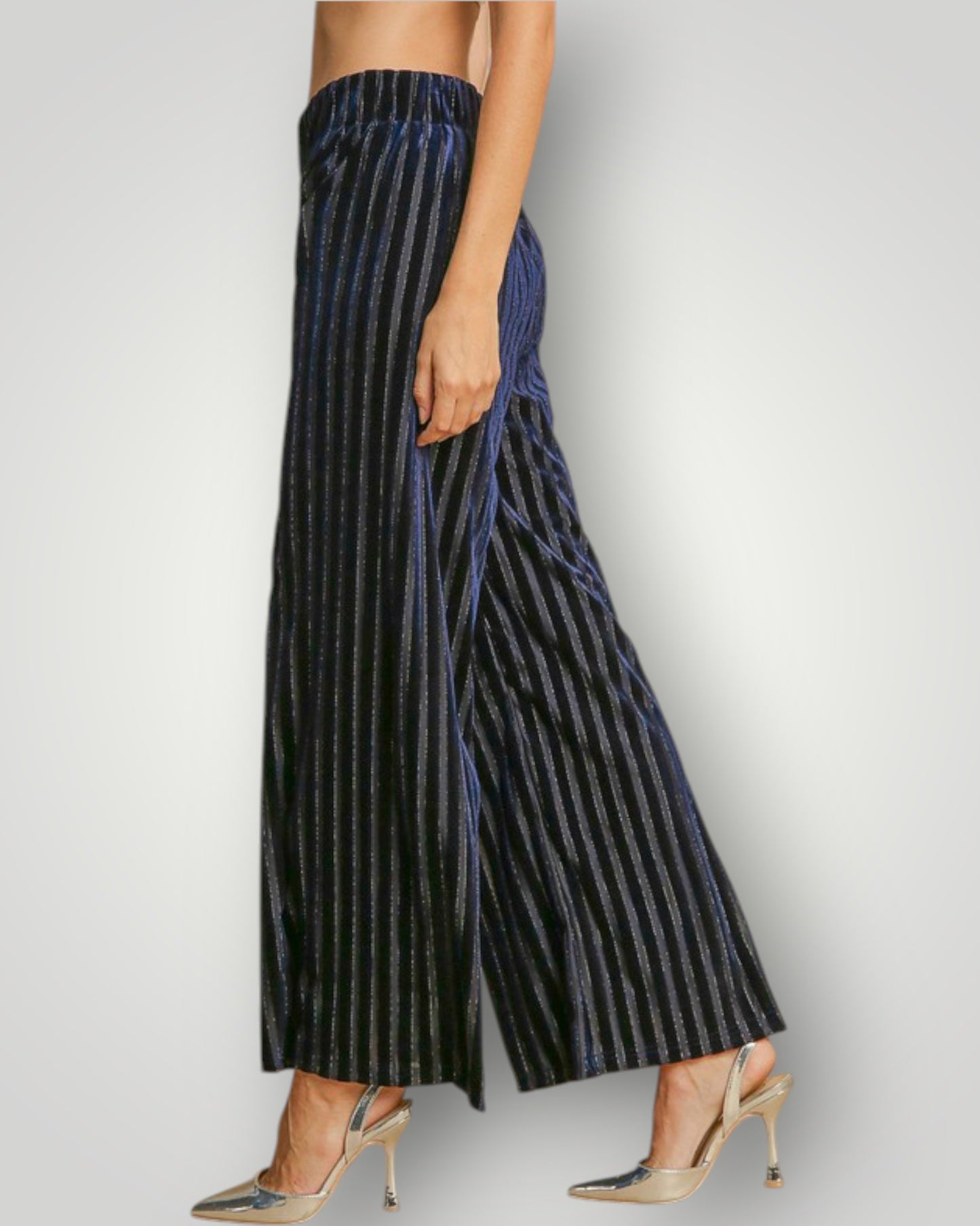 Navy striped pants worn by a person on a light gray background