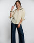 Woman wearing a beige blouse and blue pants on a white background