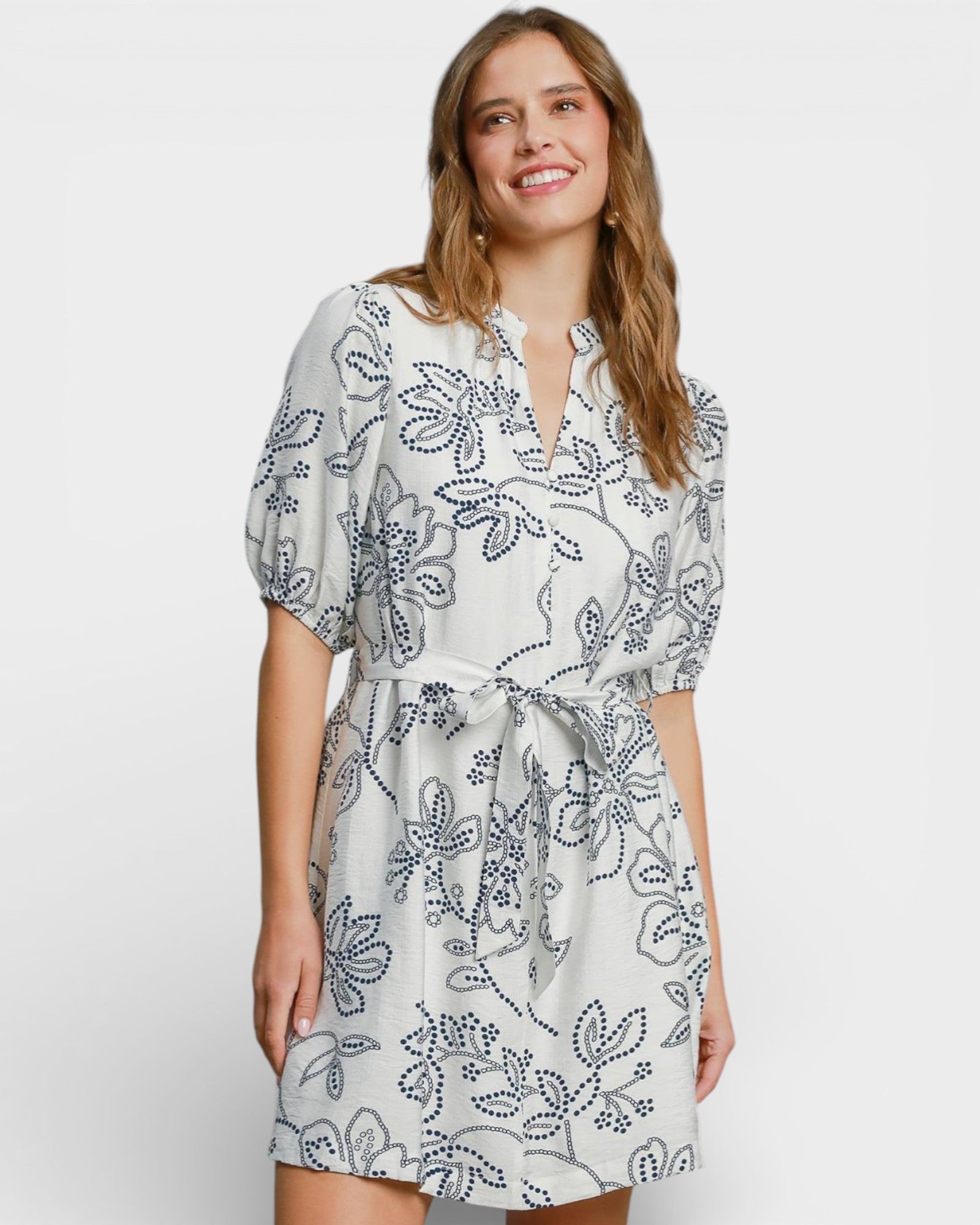 Woman wearing a floral dress on a white background