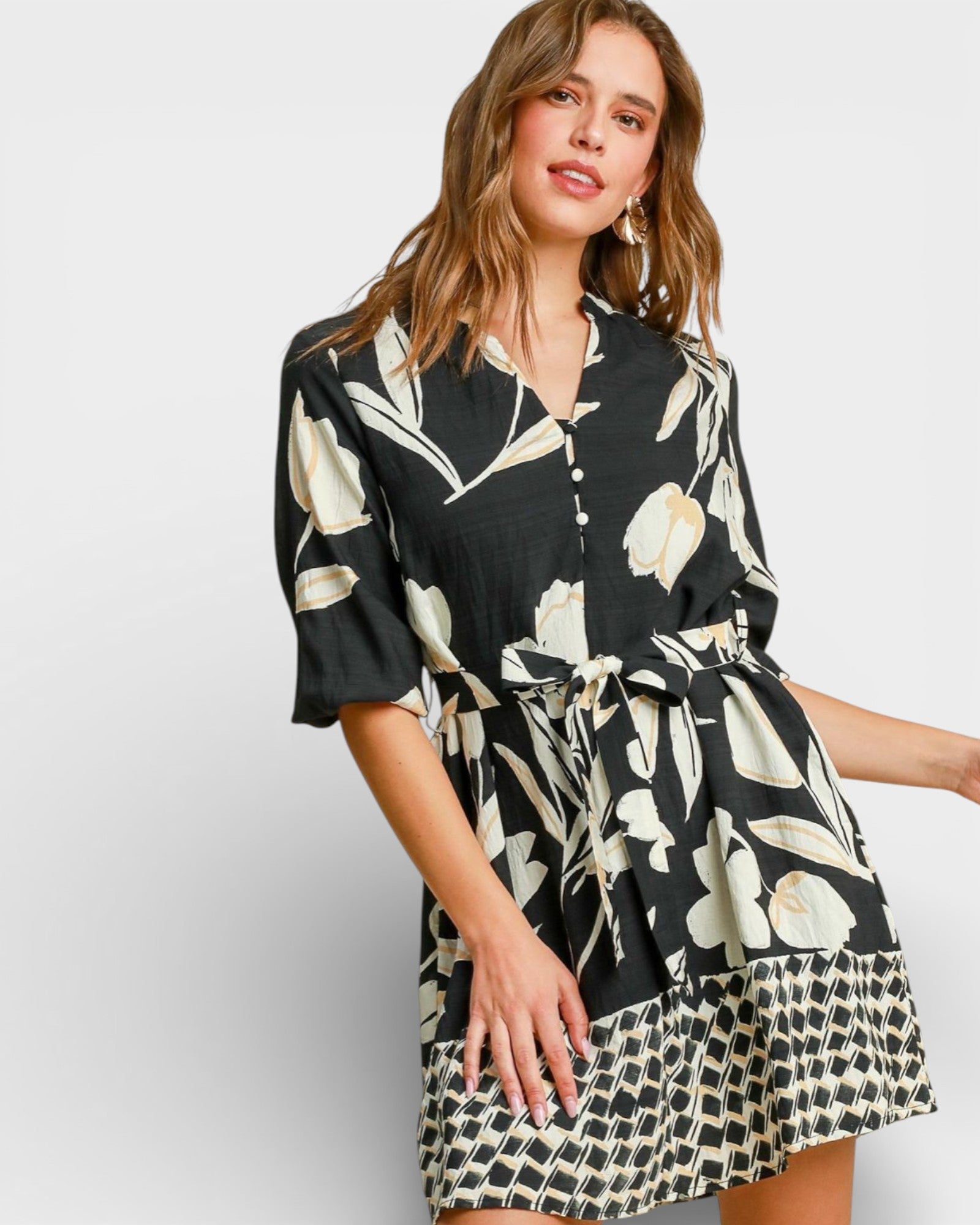 Woman wearing a black floral dress on a white background