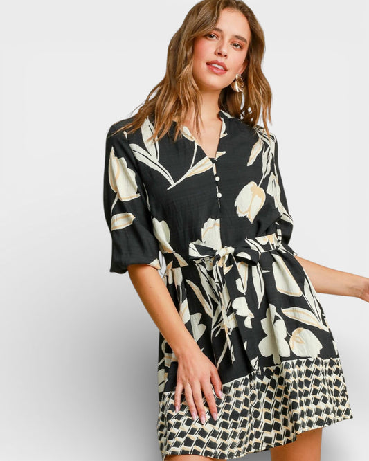 Woman wearing a black floral dress on a white background