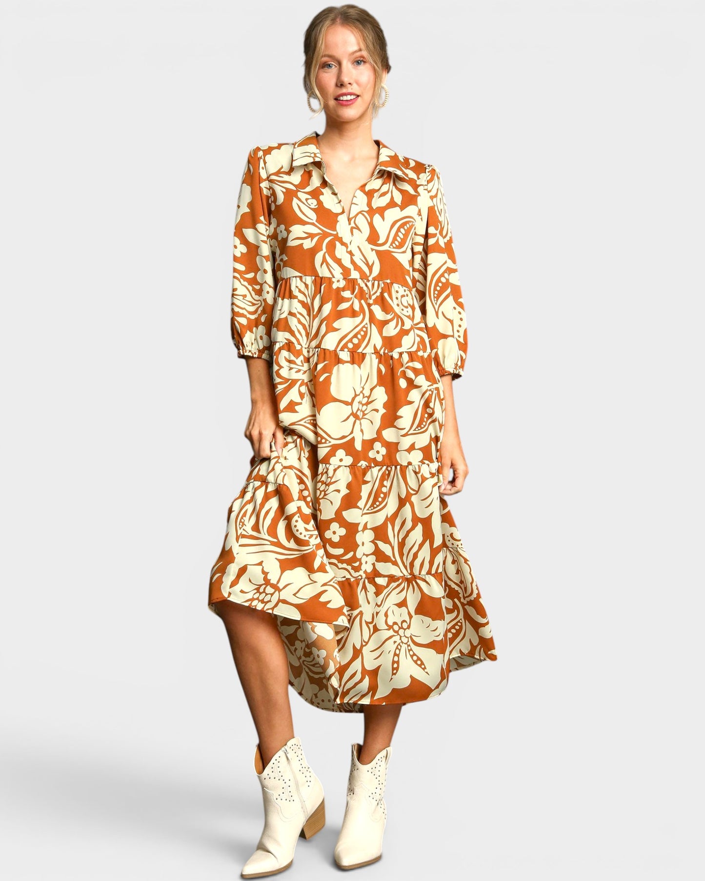 Woman wearing a floral dress with a plain background