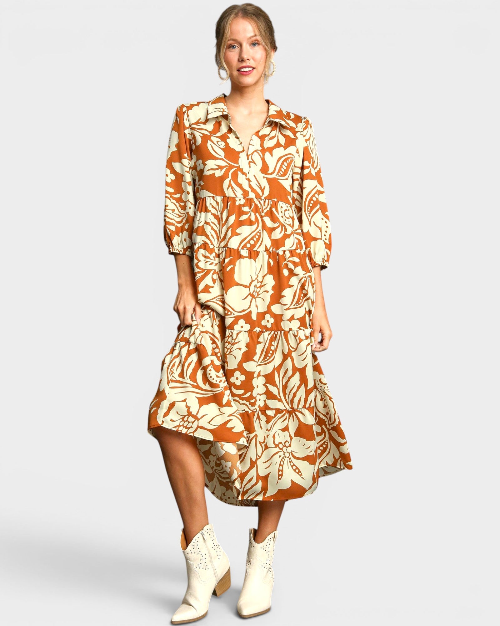 Woman wearing a floral dress with a plain background