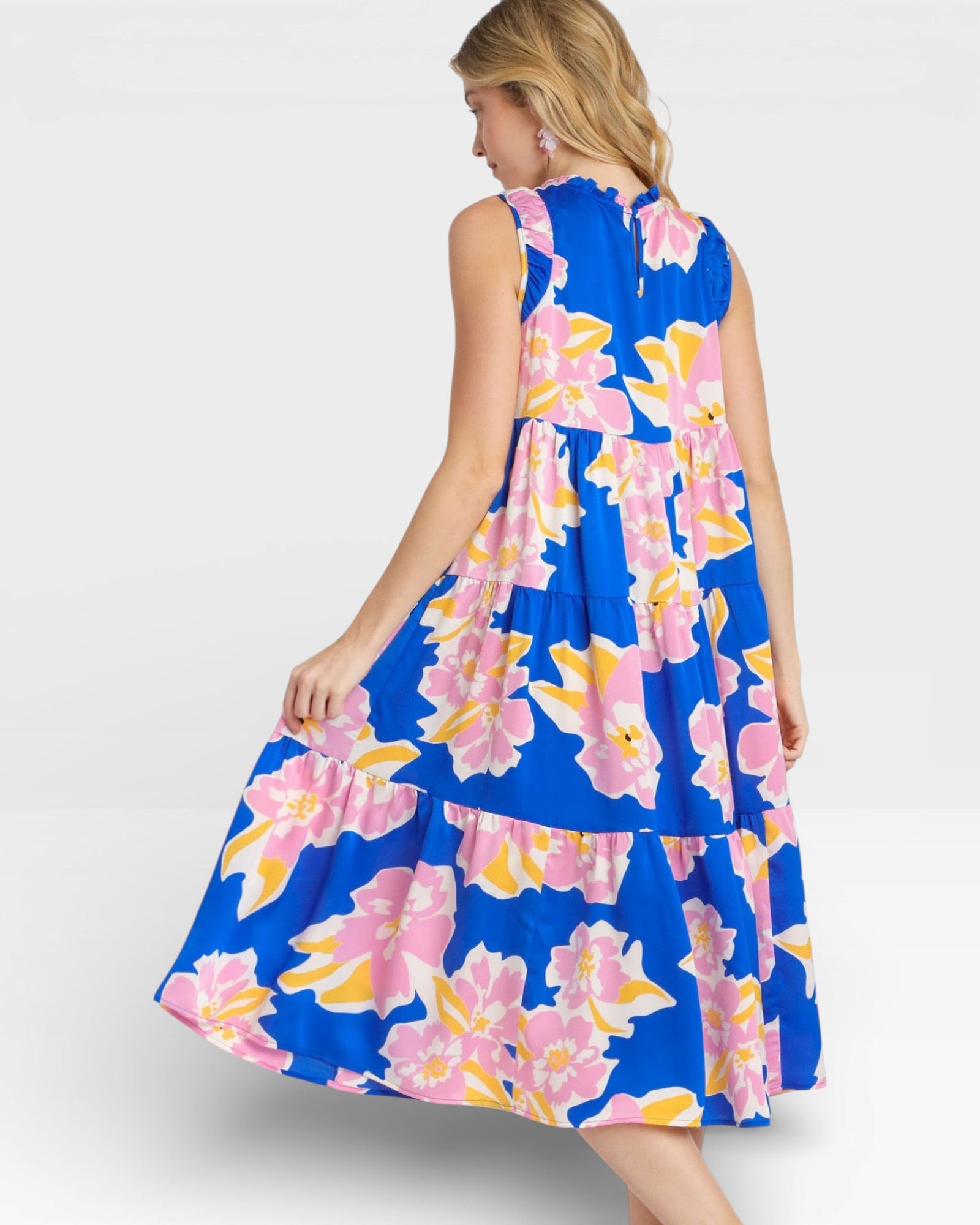 Woman wearing a blue floral dress on a white background