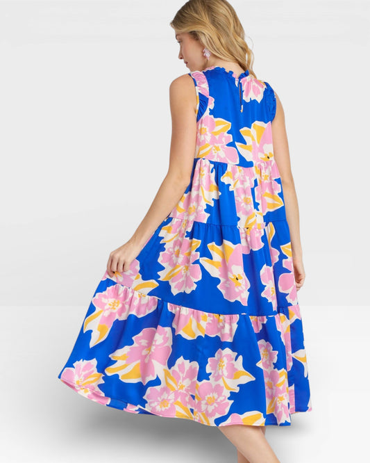 Woman wearing a blue floral dress on a white background
