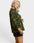 Woman wearing a green patterned blouse on a white background
