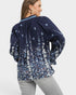 Woman wearing a navy floral blouse on a white background