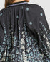 Black floral-patterned garment with a close-up view of the fabric texture.