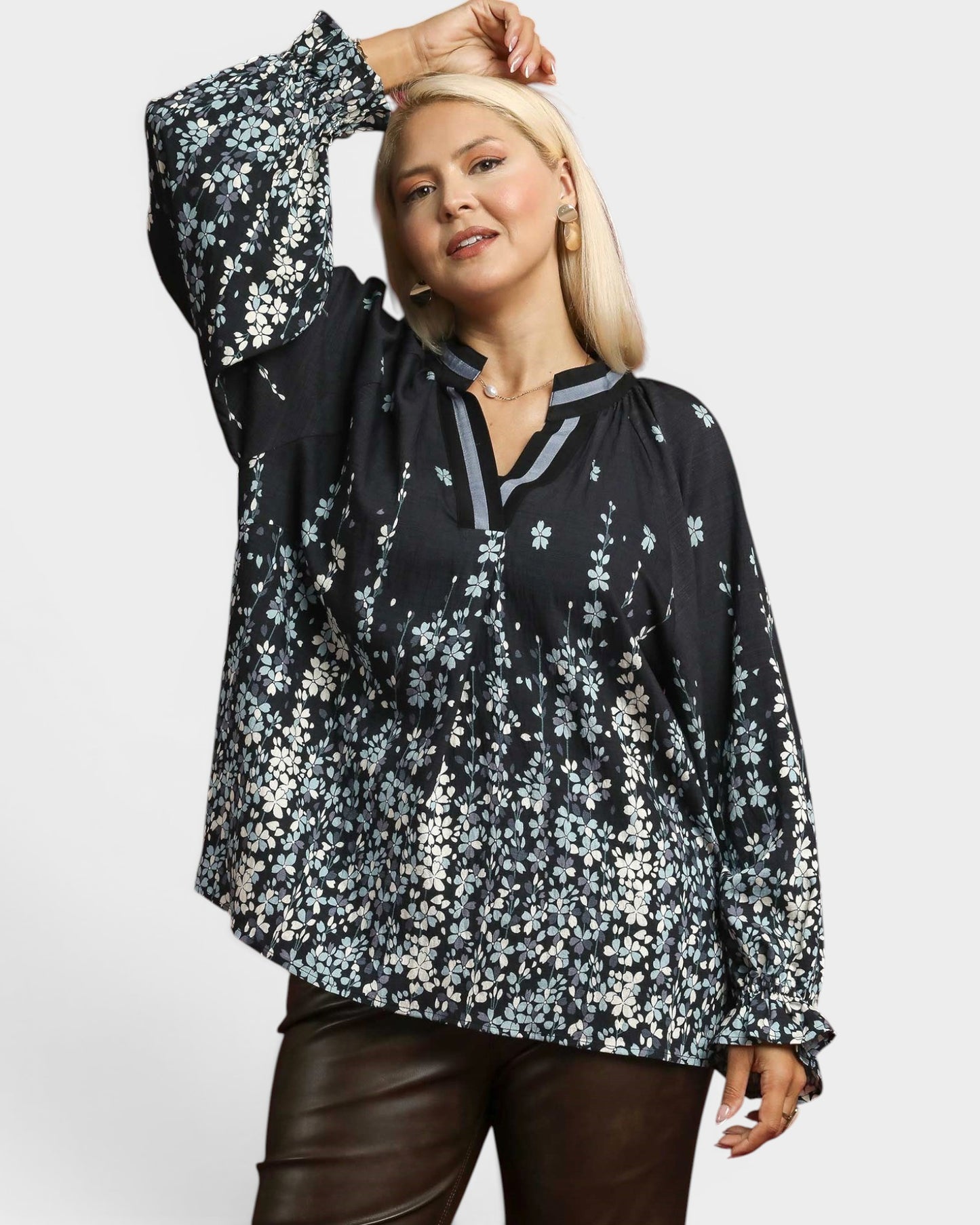 Woman wearing a black floral blouse on a white background