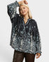 Woman wearing a black floral blouse on a white background
