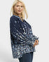 Woman wearing a navy floral blouse on a white background