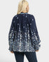 Navy floral blouse worn by a person on a white background