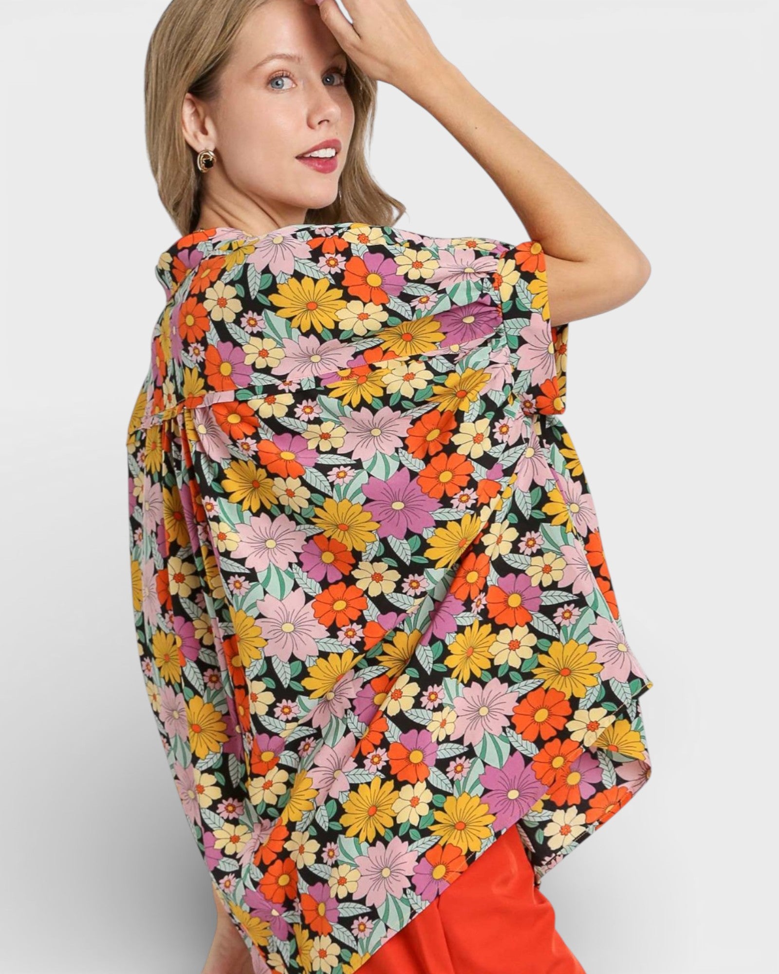 Woman wearing a colorful floral scarf on a white background