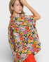 Woman wearing a colorful floral scarf on a white background