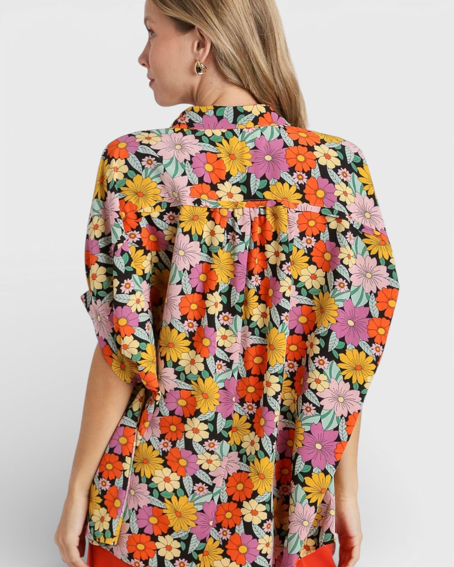 Woman wearing a colorful floral dress on a white background