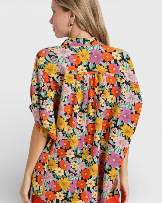 Woman wearing a colorful floral dress on a white background