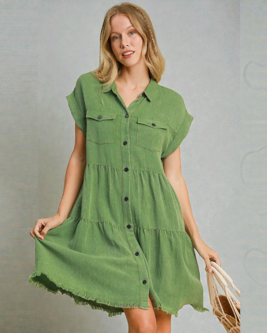 Woman wearing a green dress with a plain background