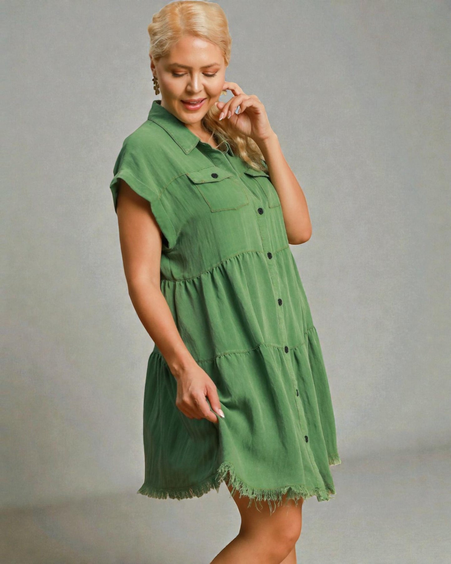 Woman wearing a green dress against a gray background