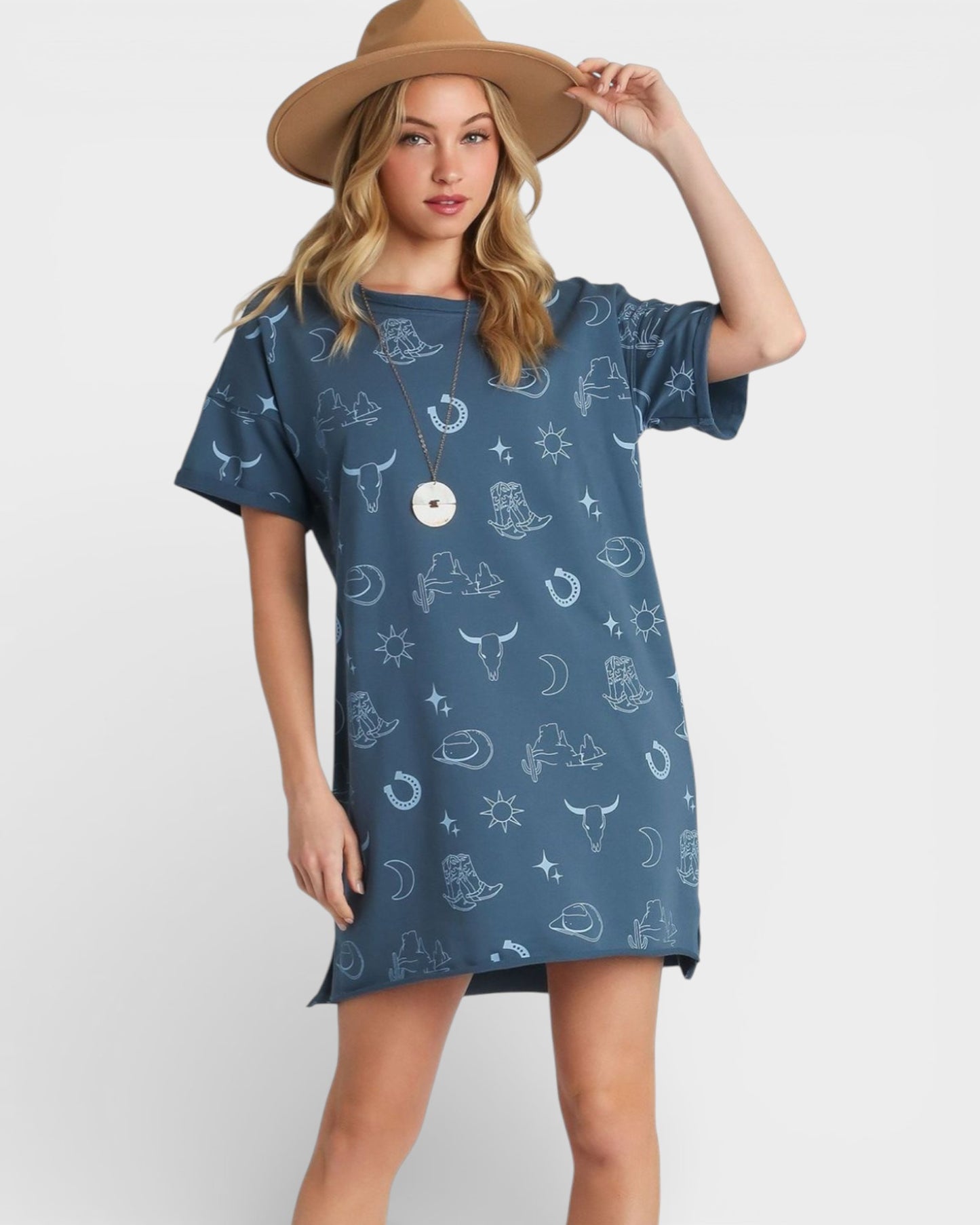 Woman wearing a blue patterned dress and brown hat on a white background