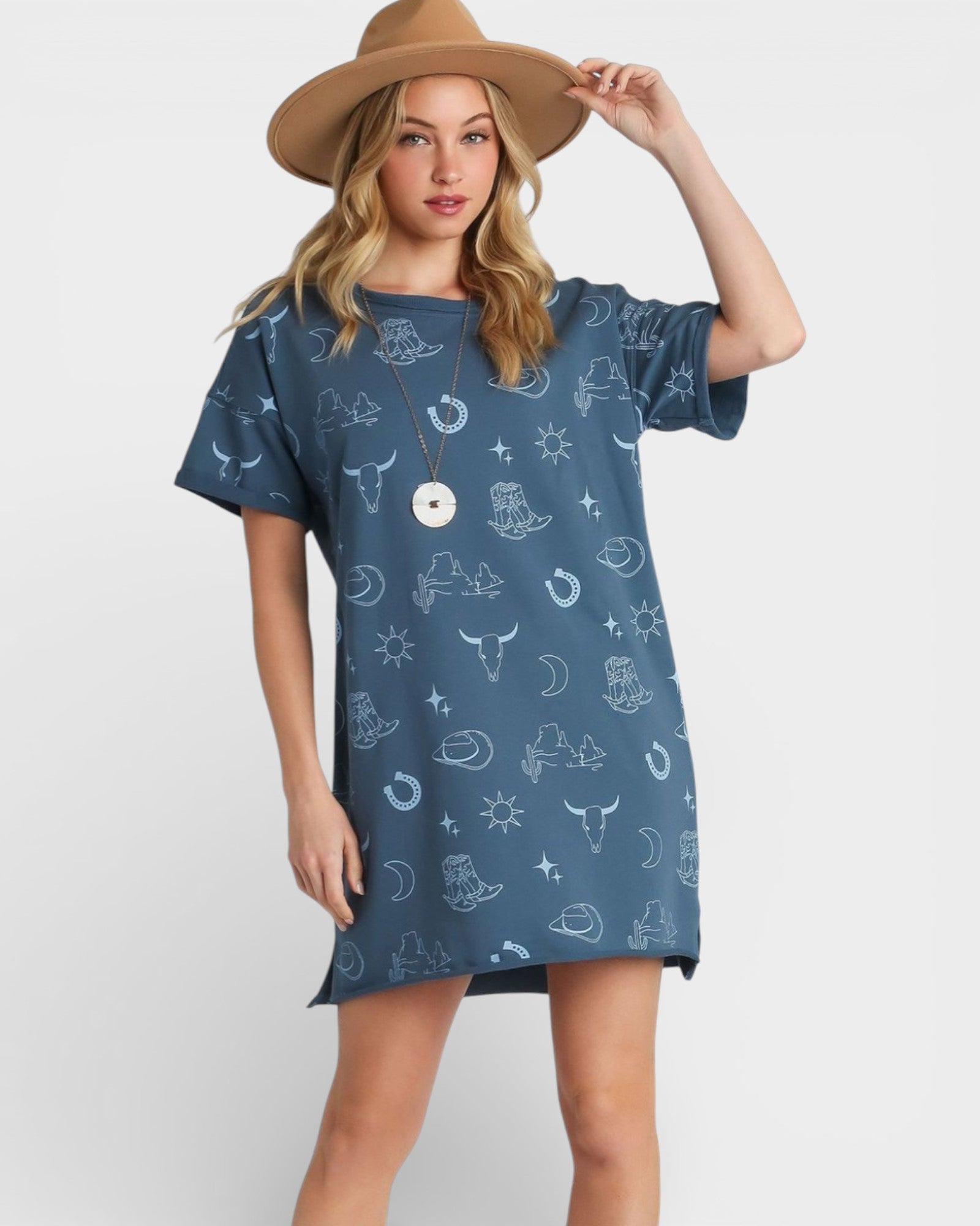 Woman wearing a blue patterned dress and brown hat on a white background