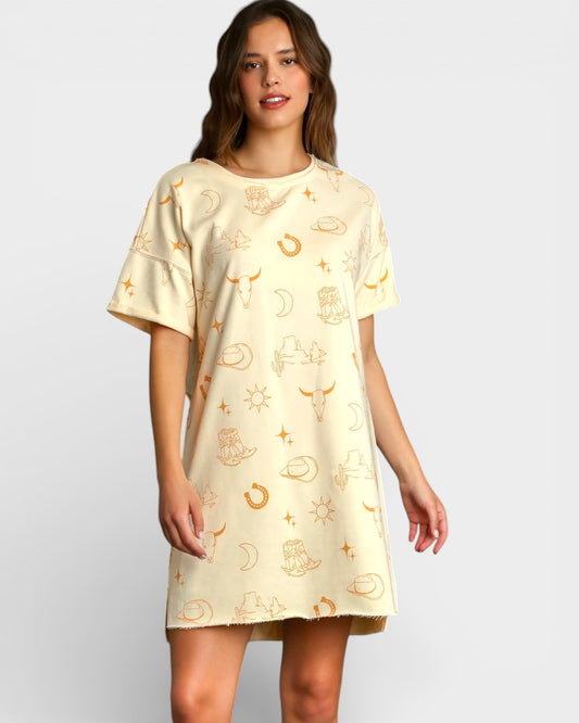 Woman wearing a cream-colored dress with gold patterns on a white background