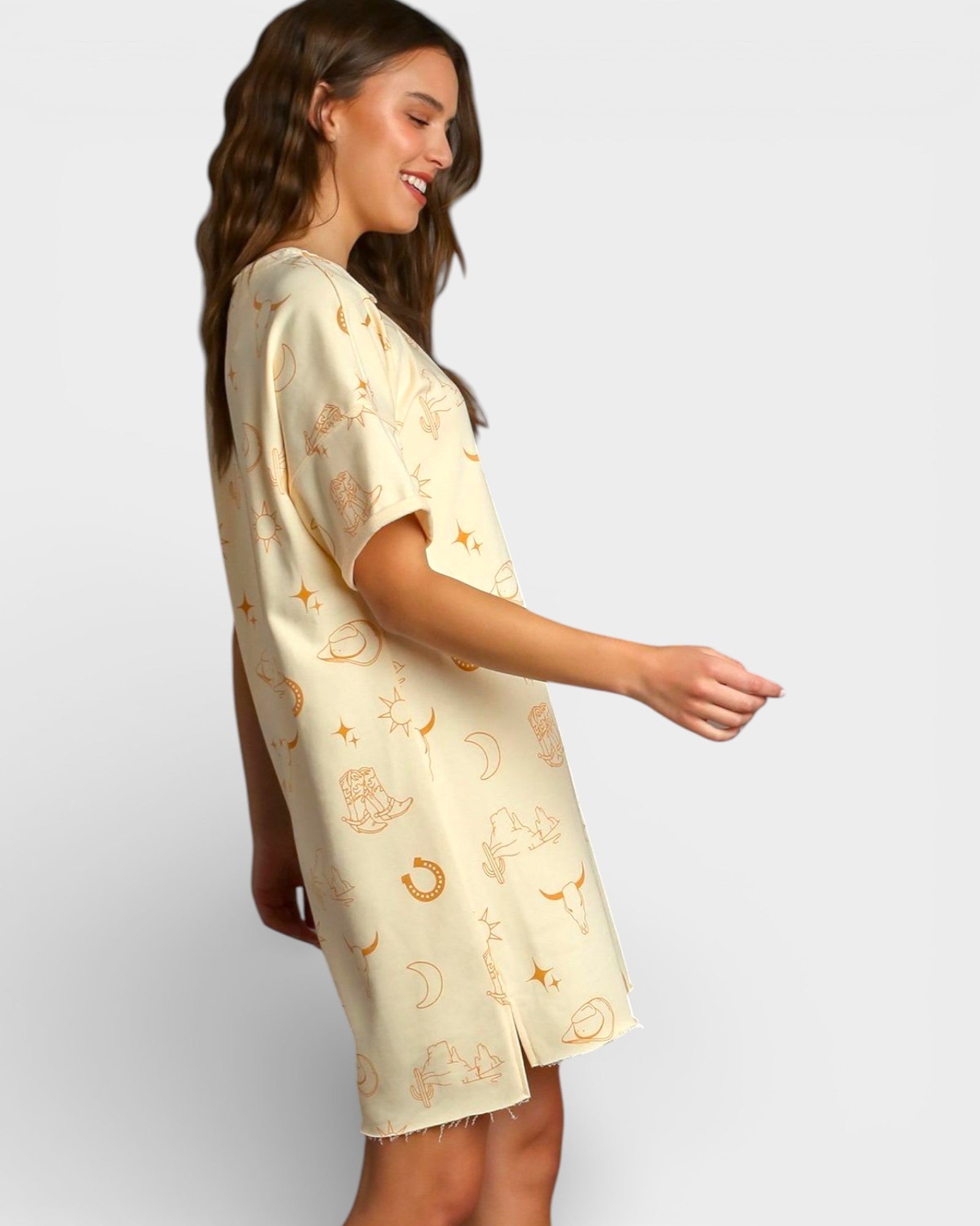 Woman wearing a light-colored dress with patterns on a plain background