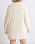 Beige textured dress worn by a person on a white background