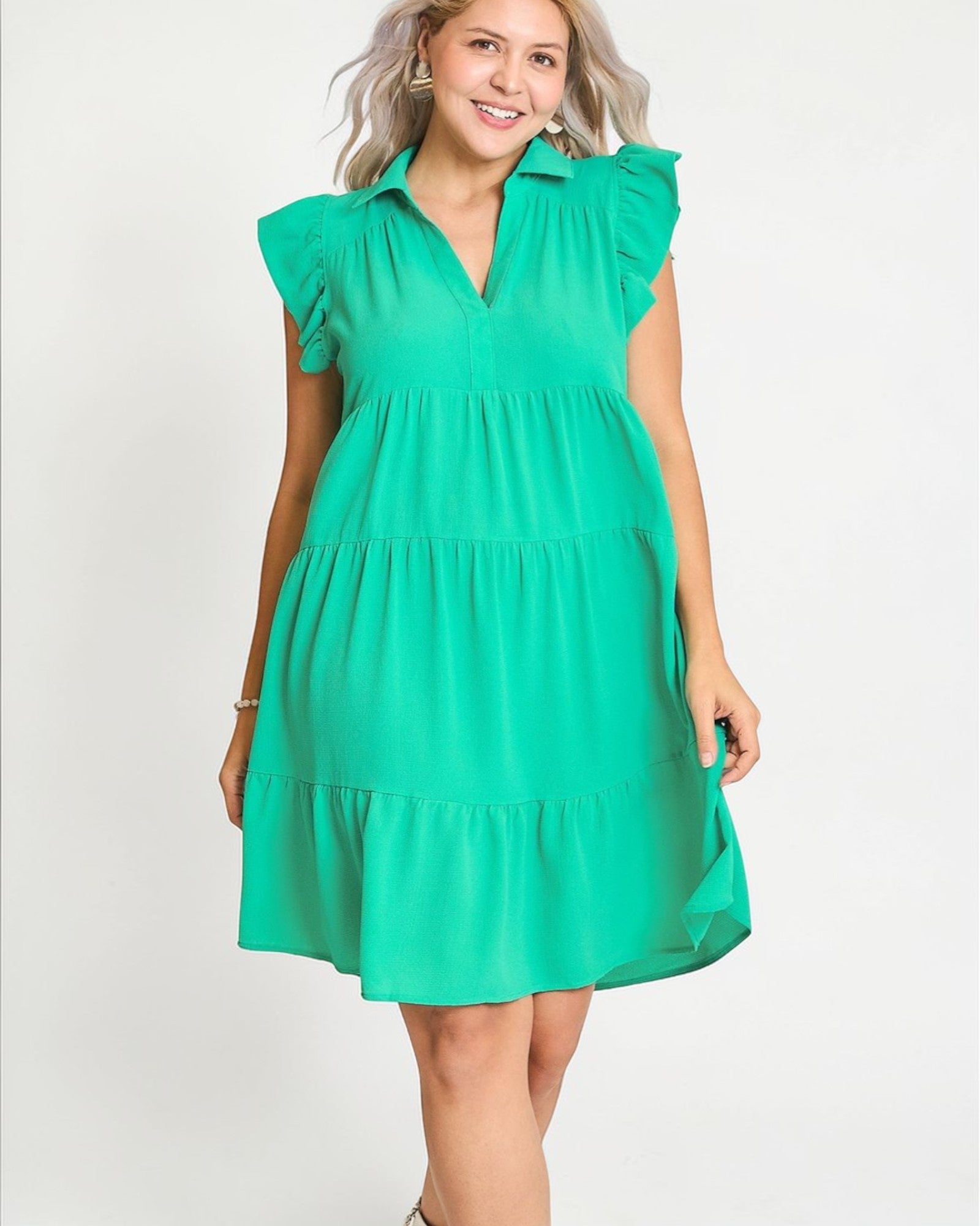 Woman wearing a green dress on a white background