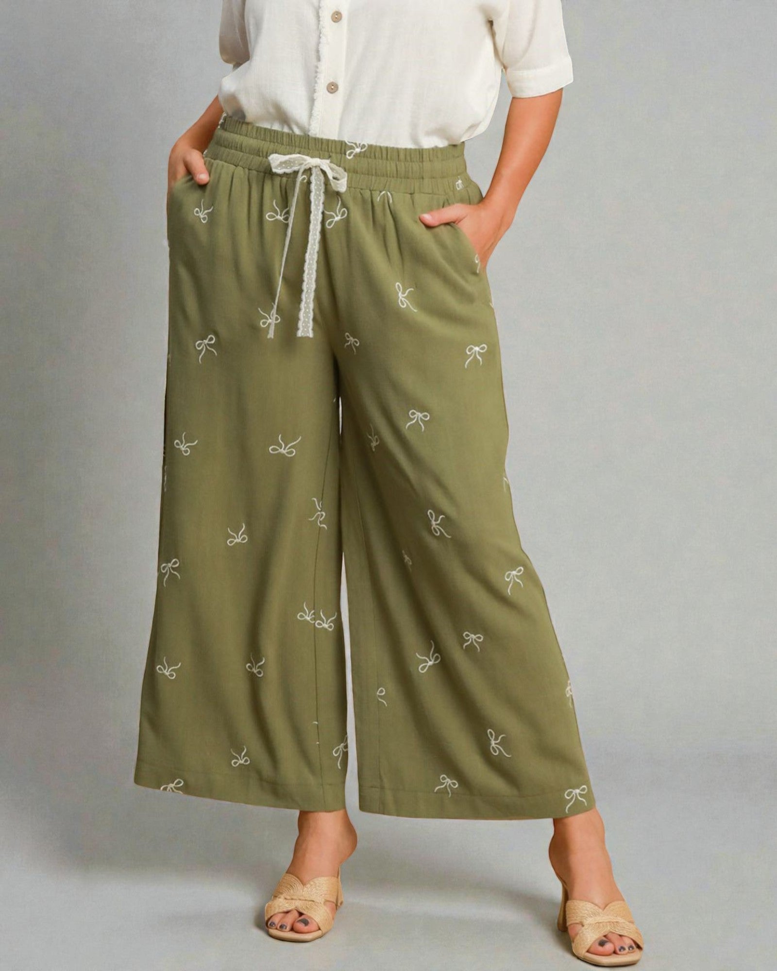 Green patterned pants worn by a person on a gray background